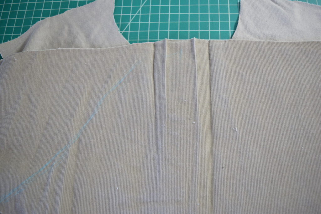 iron out pleat in back of the shirt