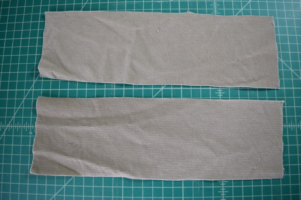 two rectangles cut from shirt sleeves
