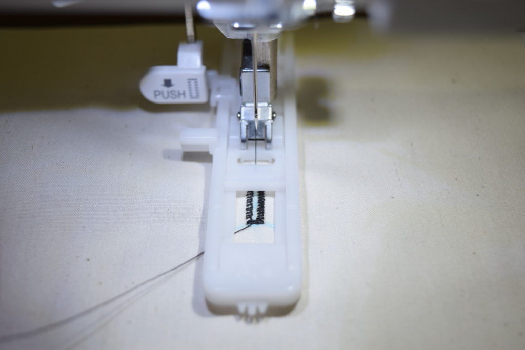 machine sewing a buttonhole with a buttonhole foot