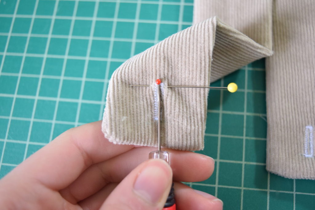 place a pin at the end of the buttonhole