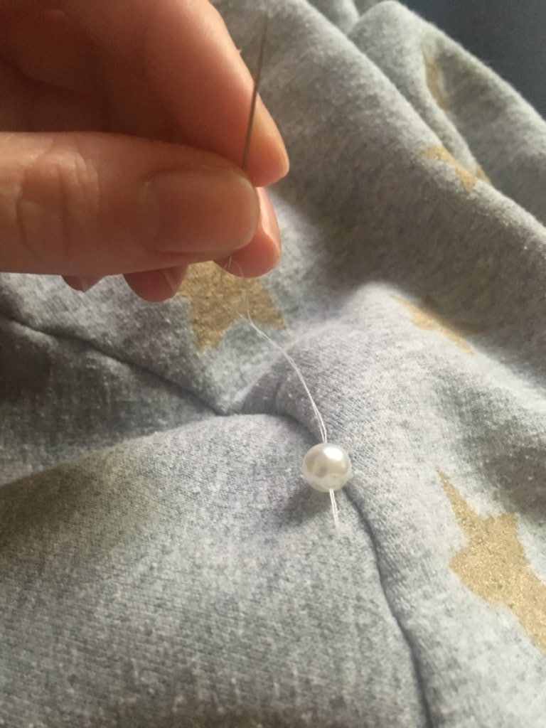 thread a pearl onto the thread