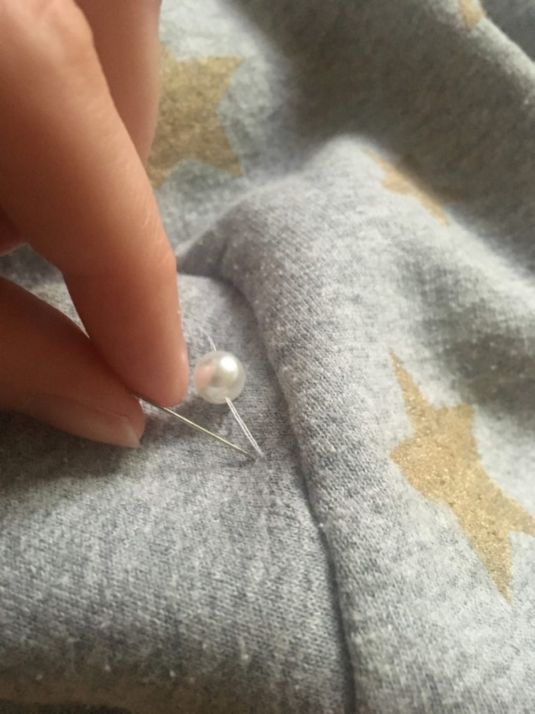 push needle back to the inside of the sweater