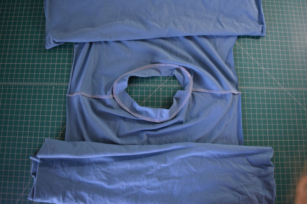 lay the shirt so the inside of the neck is facing up and centered