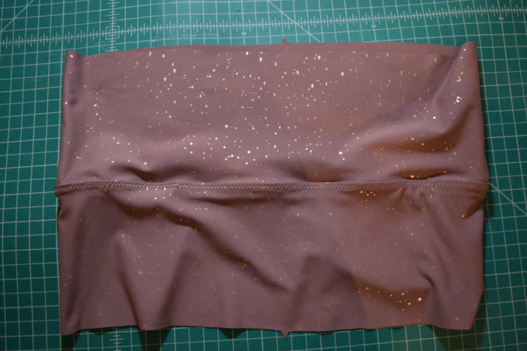 elastic topstitched to one side of waistband