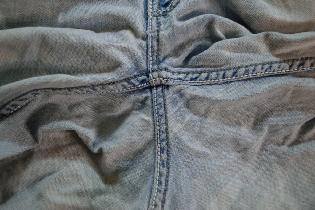 wear is showing as thin white areas in the back crotch of jeans