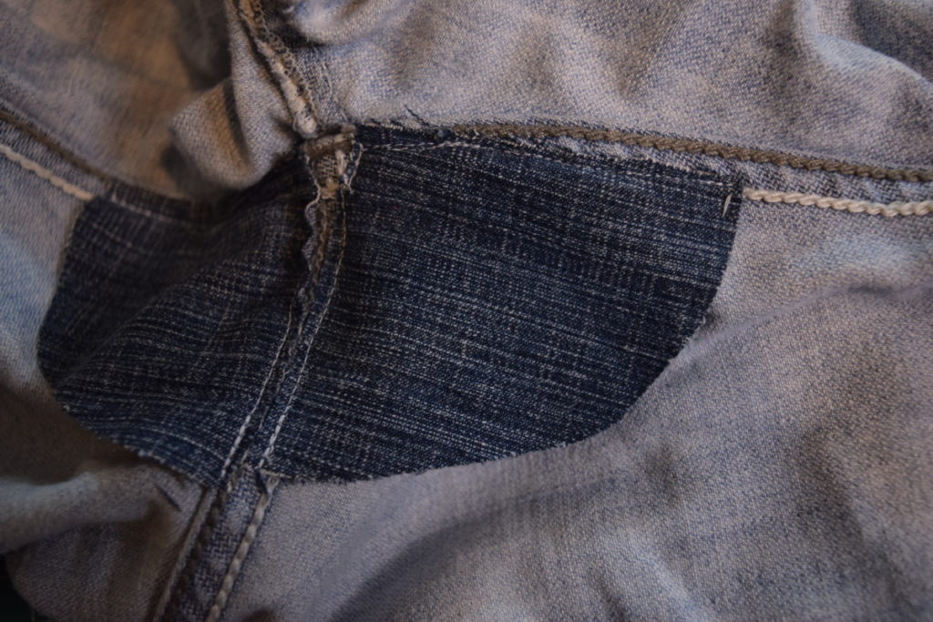 1/4 inch stitch with white thread on patch in the crotch of jeans