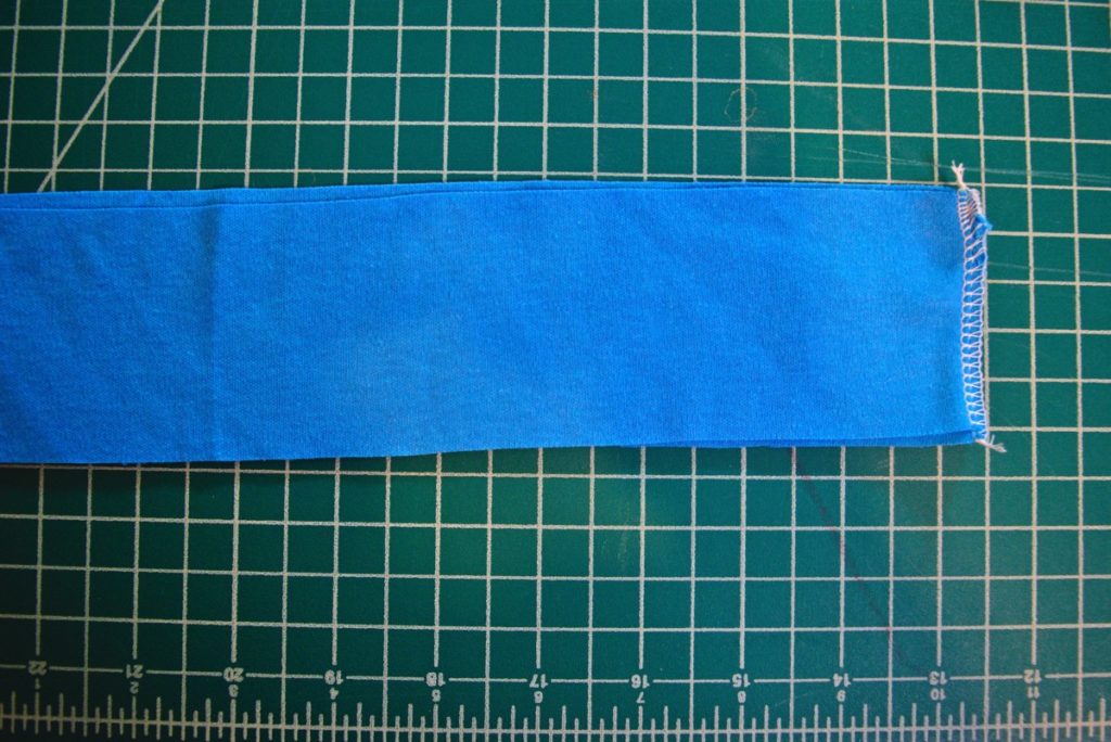 the short ends of the rectangle neckband are serged to form a loop