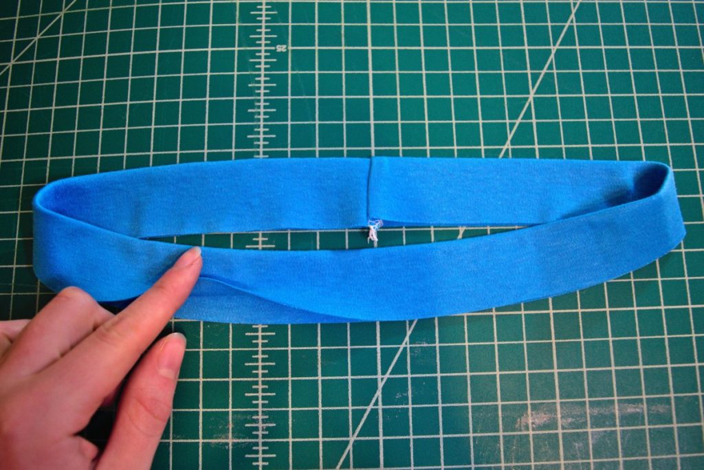 blue knit neckband pressed in half lengthwise to form a pretty neckband with the bottom edge still open