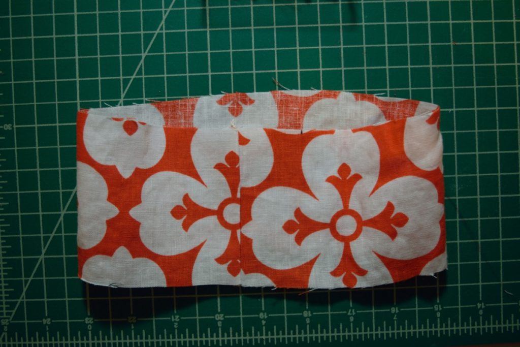 a loop of orange and white linen fabric