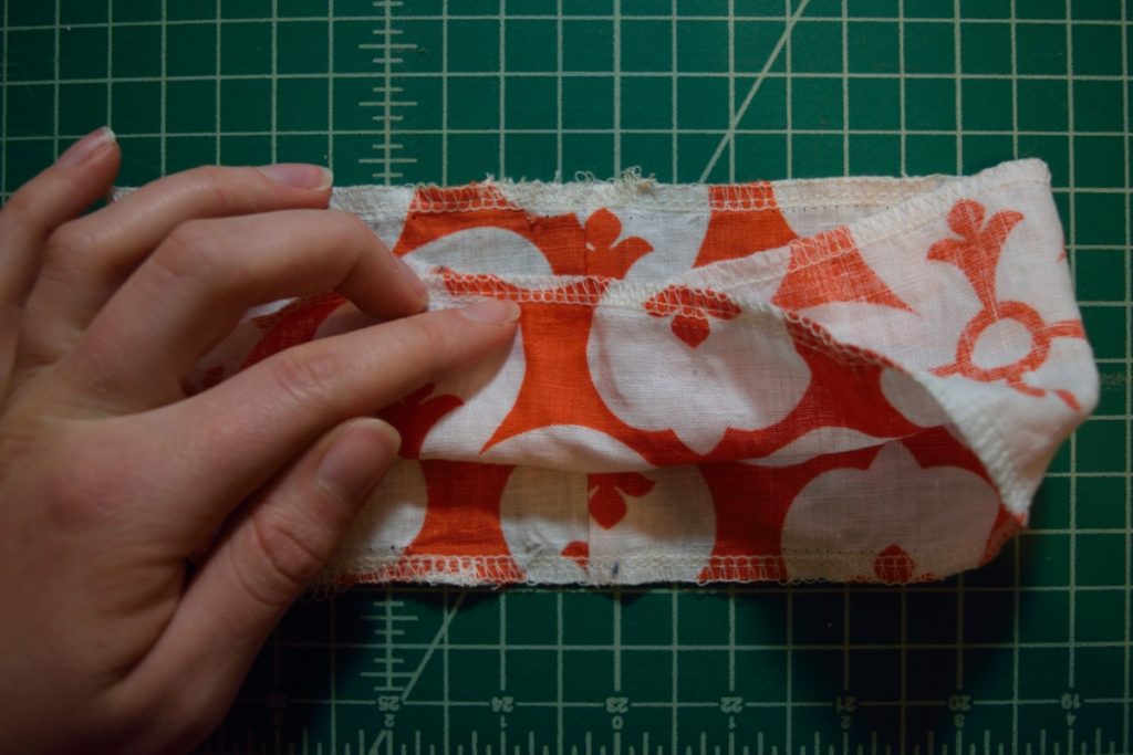 folding the top layer of scrunchie into the center of the bottom layer