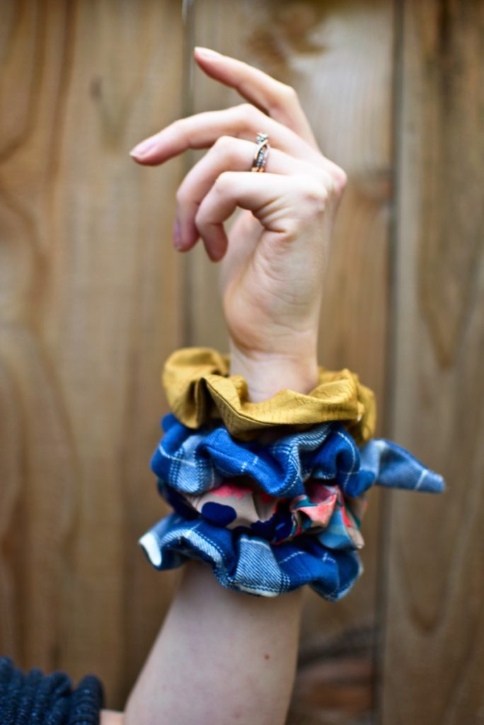 an arm with four scrunchies displayed on the wrist