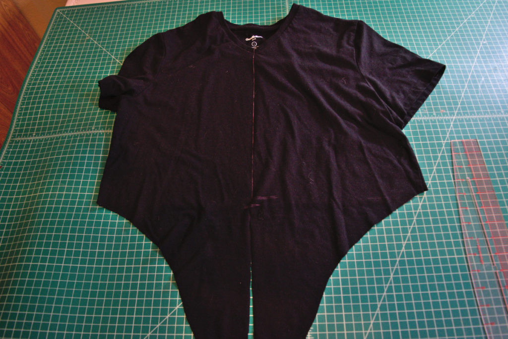 a pink chalk line drawn straight up the center front of a black t shirt
