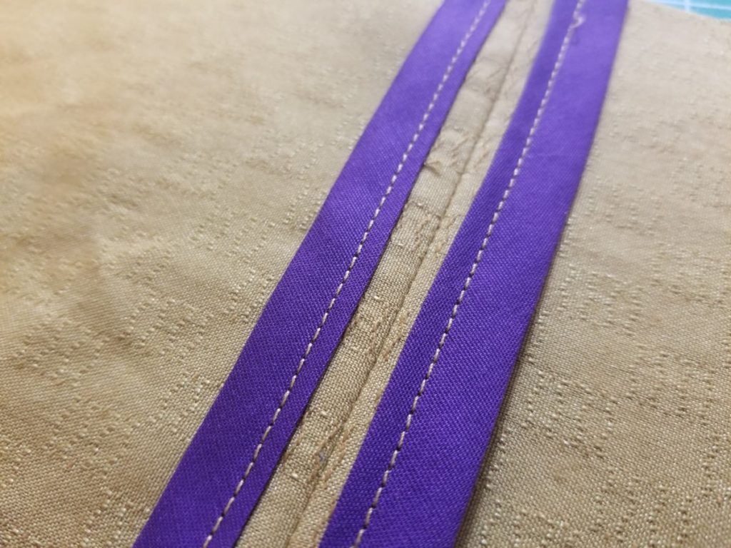 purple bias bound seams on mustard fabric