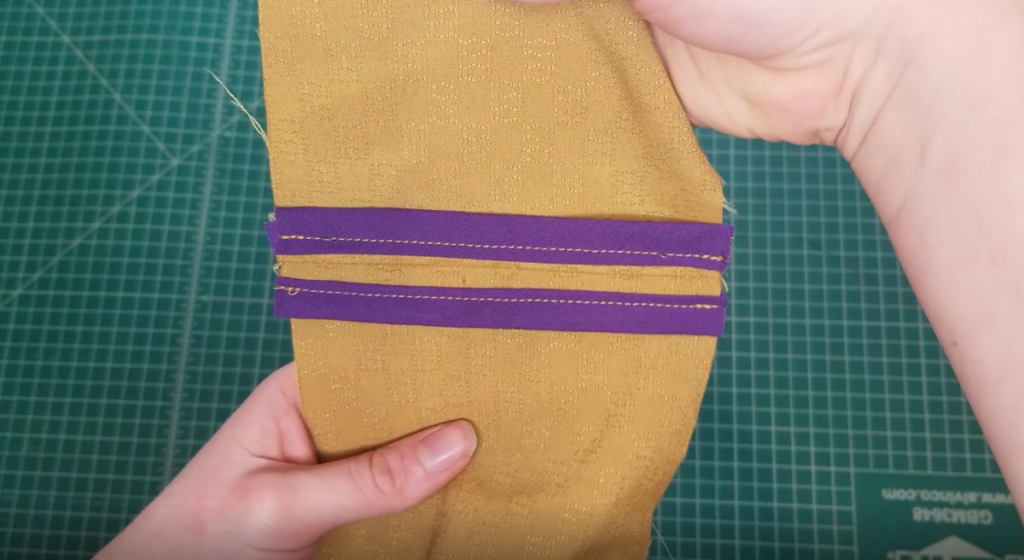 a purple bias bound seam on mustard fabric