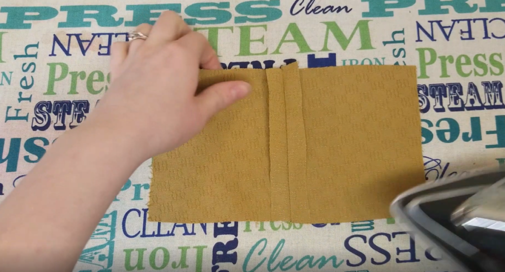 seam allowances are pressed open on a mustard fabric