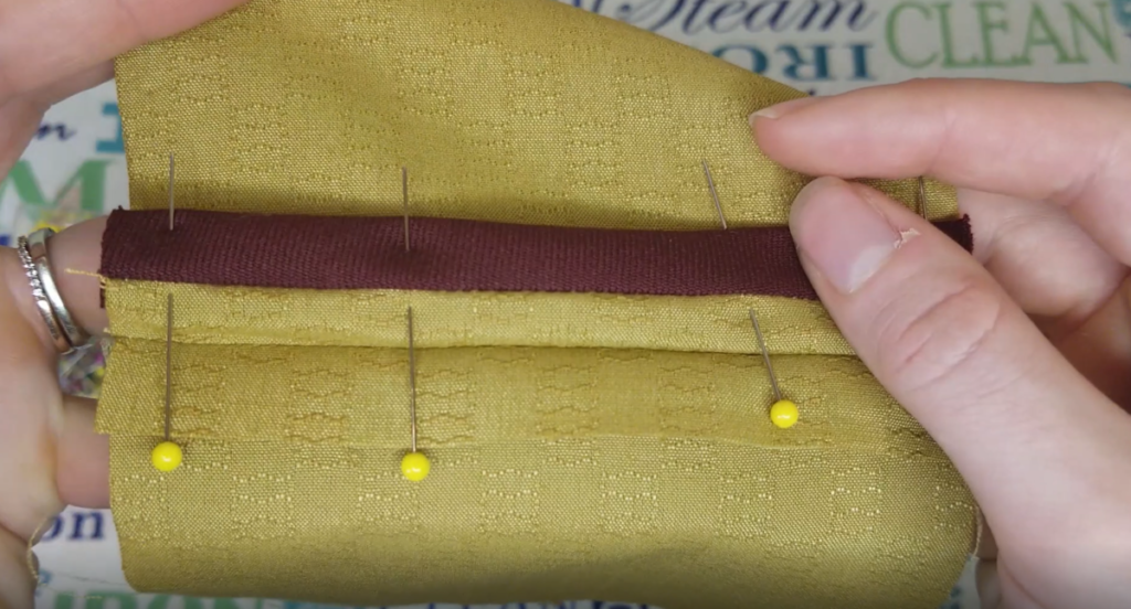 bias is pinned around the seam allowance to sew a hong kong seam