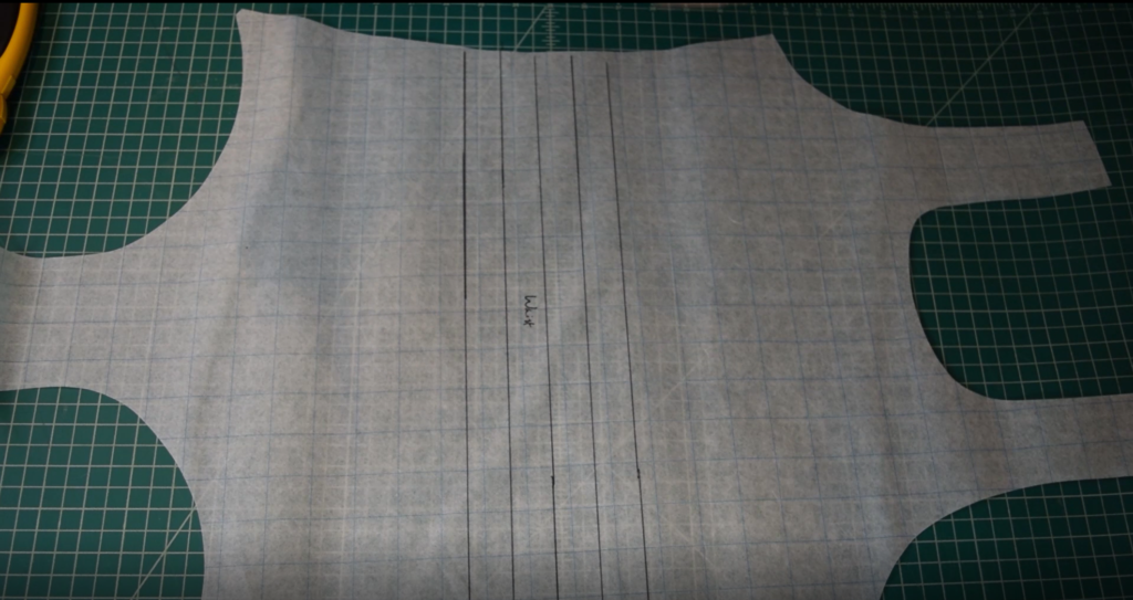 lines are drawn on the swimsuit pattern to prepare for taking out length