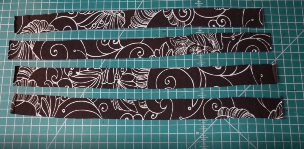 four strips of brown and white swim fabric to make ties
