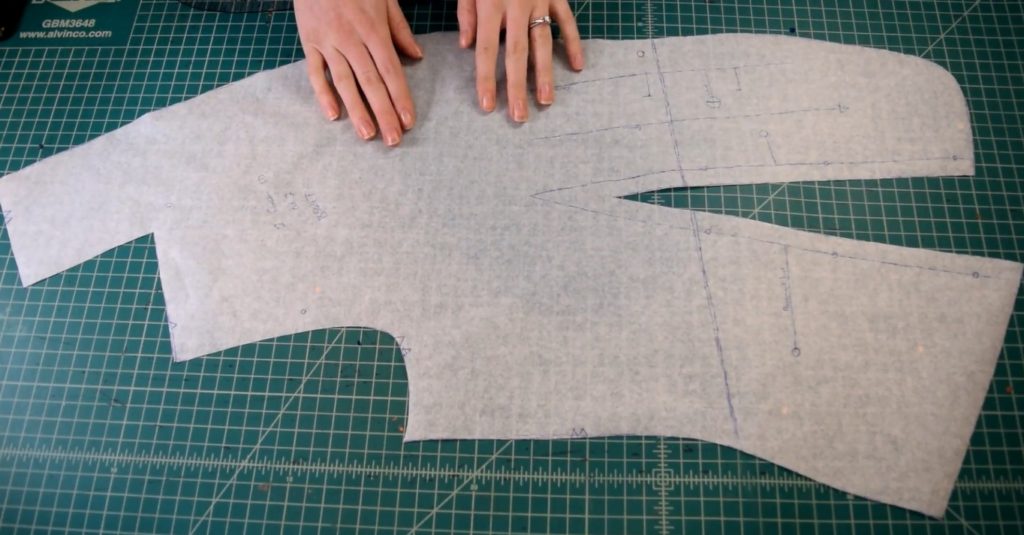 vest front pattern with a large waist dart on a green cutting mat